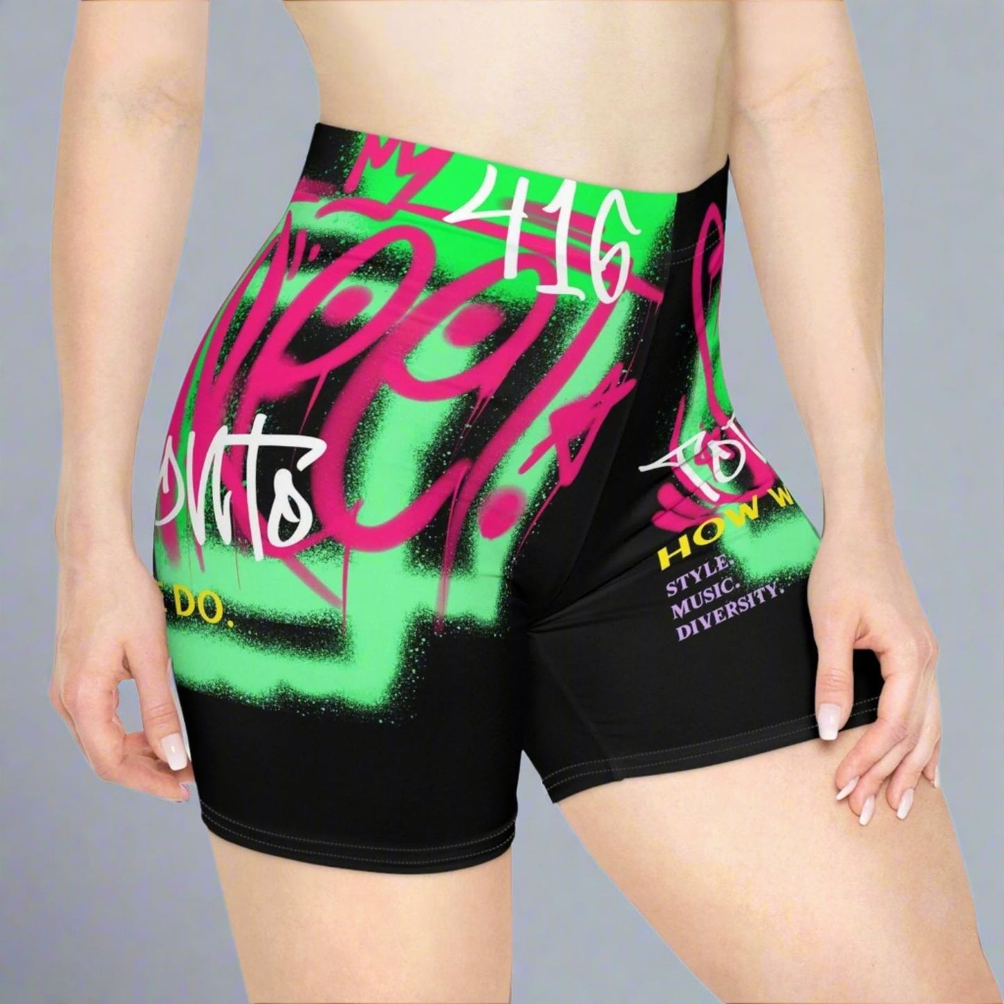 Black Toronto shorts with colorful graphics and text by a gray background | Ohhh So Swag