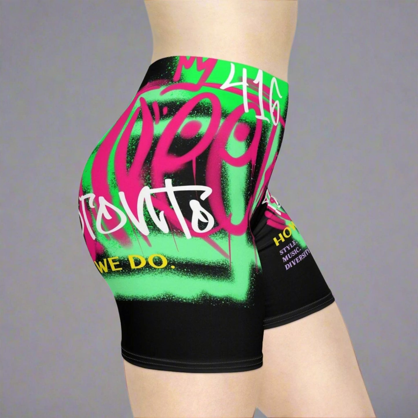 Black and neon biker shorts with Toronto and 416 text and graffiti graphics in front of a gray background | Ohhh So Swag