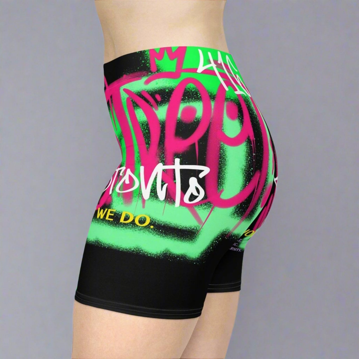 Black biker shorts about Toronto with bright neon graffiti graphics worn in front of a gray background | Ohhh So Swag