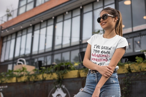 smiling-woman-in-the-city-wearing-trendy-sunglasses-and-answered-prayers-tshirt-Ohhh-So-Swag