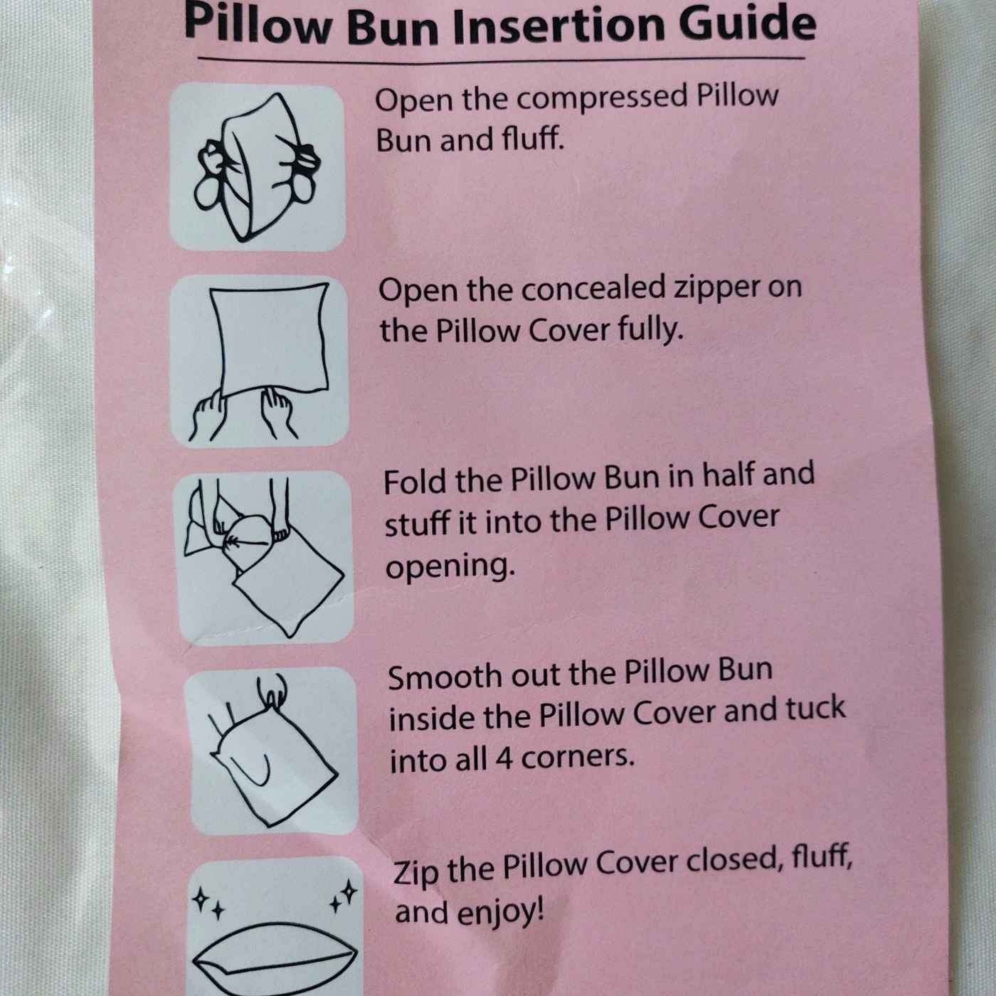 Instructions for pillow bun insertion on a pink card with illustrations.