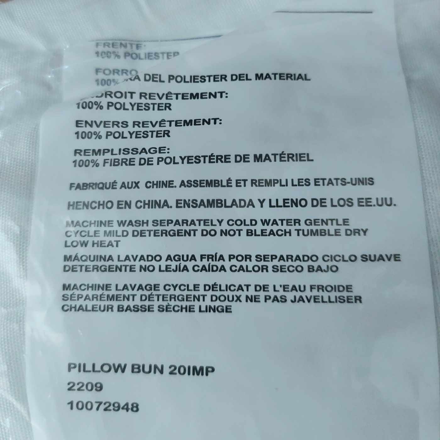 Text label on a pillow with fabric information and care instructions.